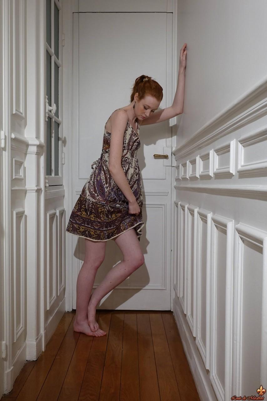 Pale redhead Nathalie Lawson exposes her upskirt underwear in a hallway(15)