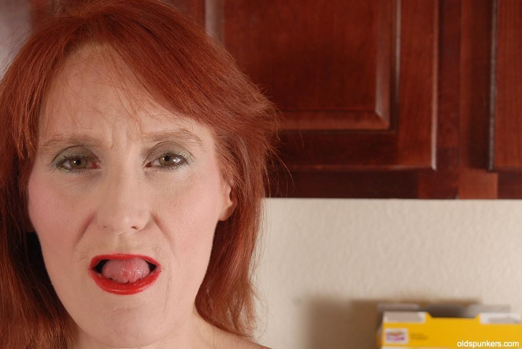 Redhead granny Debra is lying naked on the floor and masturbating(1)