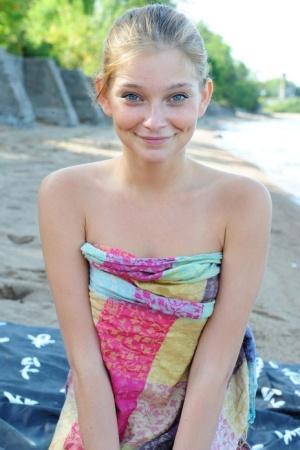 Cutie with blue eyes and innocent smile Indi shows teen body off on the beach