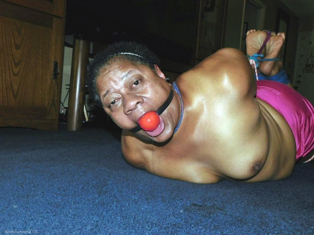 Overweight black woman Trixie struggles against a ball gag while hogtied(5)