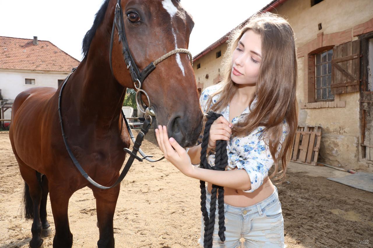 Big breasted teenage farmer Milla taking her favorite horse for a walk(10)