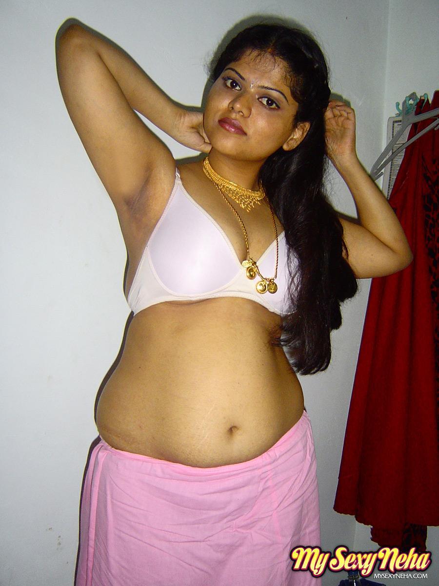 Plump Indian girl Neha gets totally naked on her bed in solo action(4)