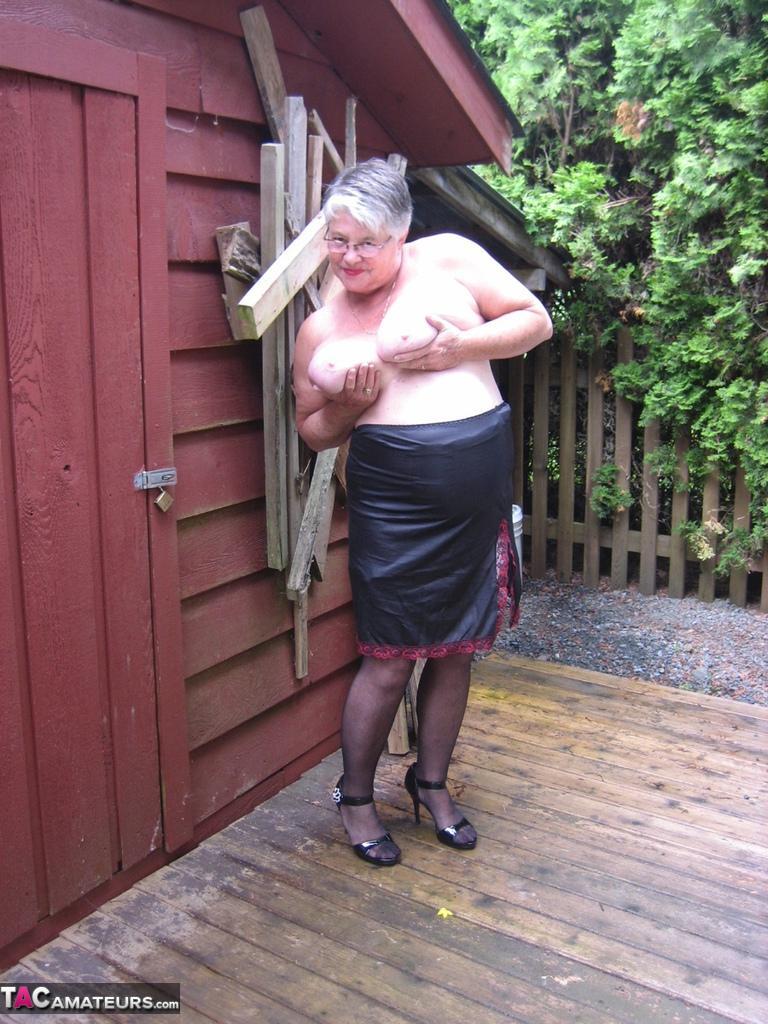 Fat oma Girdle Goddess unleashes her large boobs next to a boarded-up building(15)