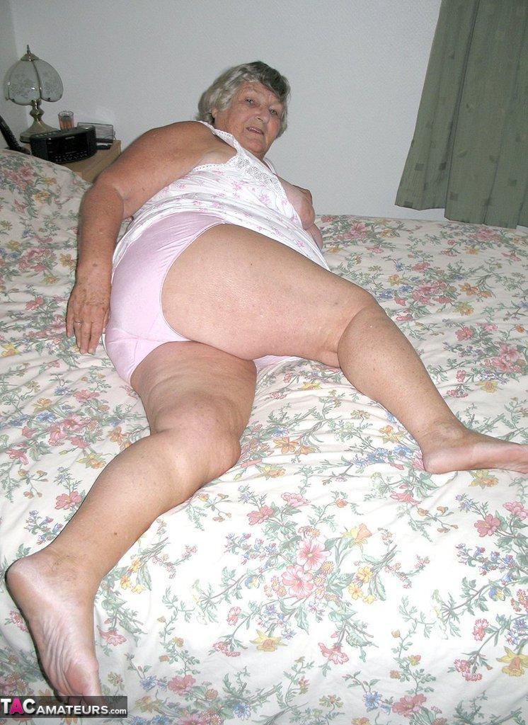 Old woman Grandma Libby grabs her fat roll after getting naked on a bed(7)