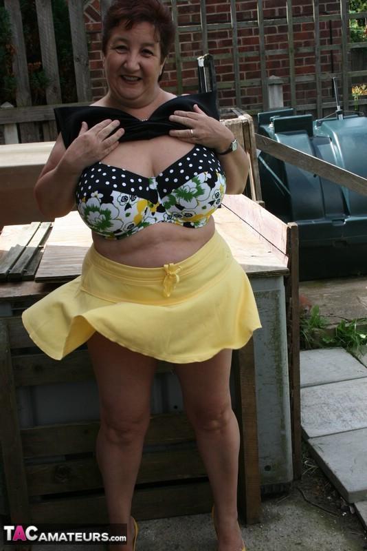 Fat older woman Kinky Carol flashes her bra and upskirt underwear on a patio(16)