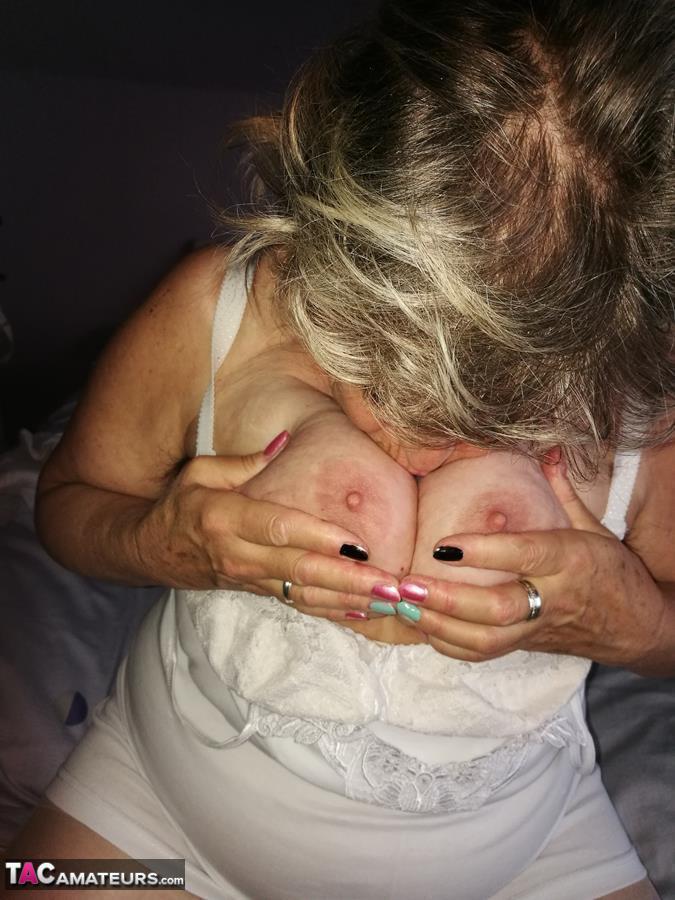 Naughty granny exposes her boobs while changing attire in nylons and heels(16)