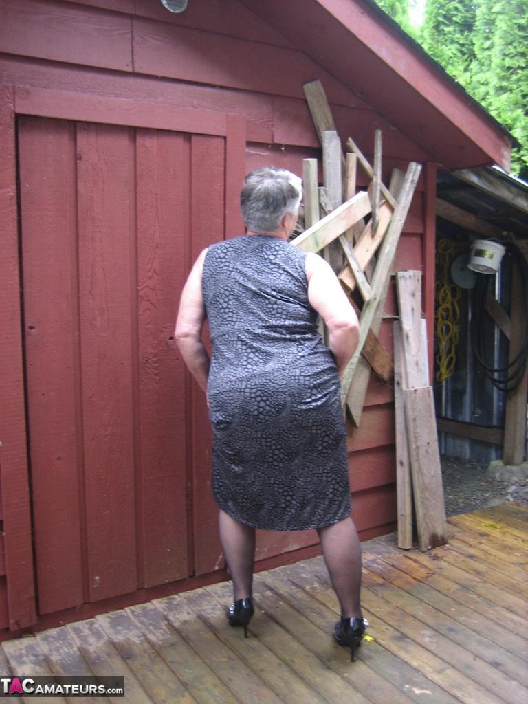 Fat oma Girdle Goddess unleashes her large boobs next to a boarded-up building(2)