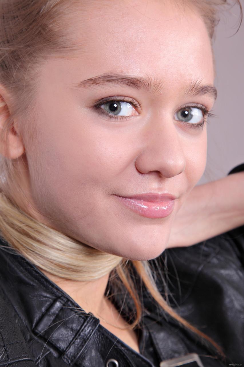 Charming teen Sara B exposes her little bush while teasing in a leather jacket(3)