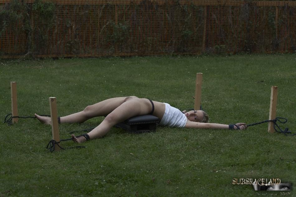 Young blonde girl is tortured in the backyard by her captor(6)