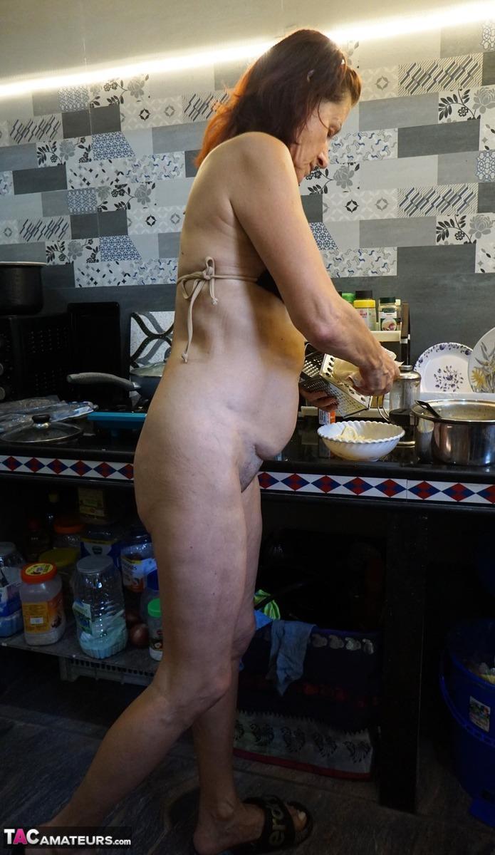 Mature lady Diana Ananta cooks up a meal while wearing a bikini(13)