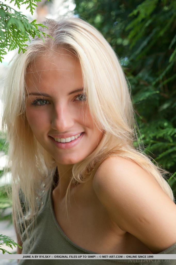 Young blonde female Jaime A stripping off clothes to model naked outdoors(1)