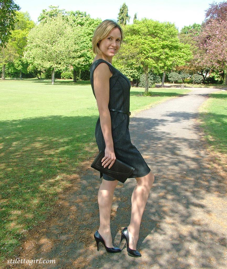 Clothed business woman shows off her sexy legs in high heels in the park(13)