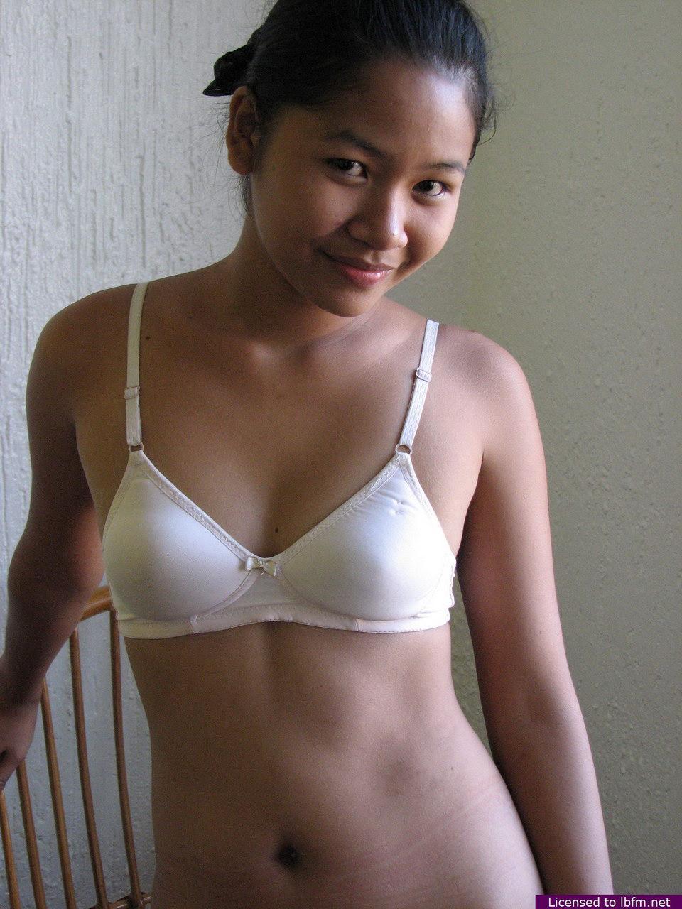 Barely legal Asian girl casually strips off her clothes for nude poses(2)