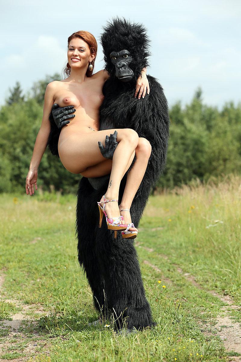 Sexy redhead cosplay chick Becca romps nude outdoors in heels with gorilla(2)