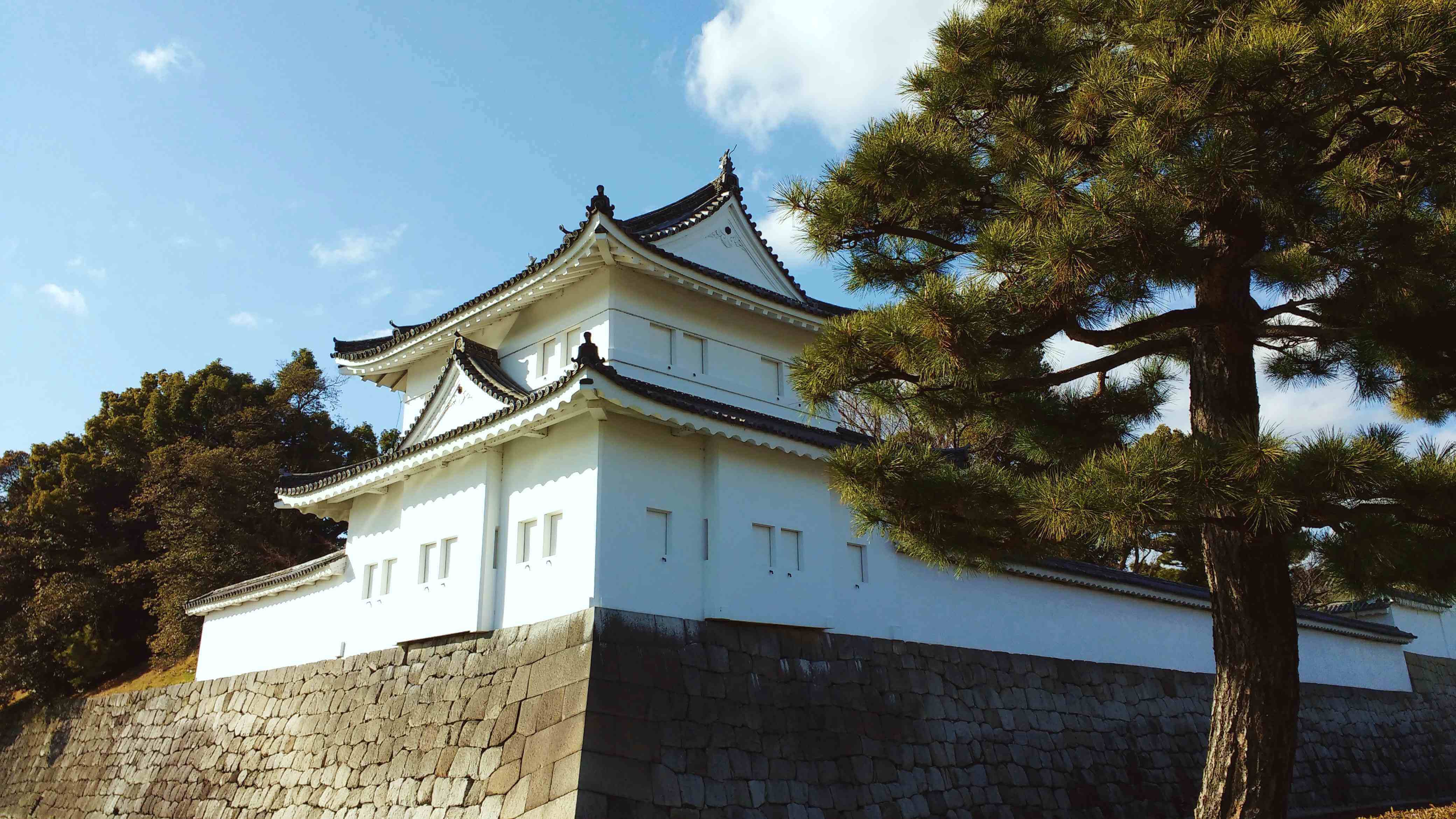 The outer walls of a white Japanese castle