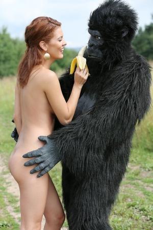 Sexy redhead cosplay chick Becca romps nude outdoors in heels with gorilla