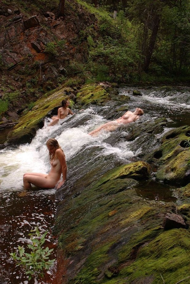 Naked woman lie in river