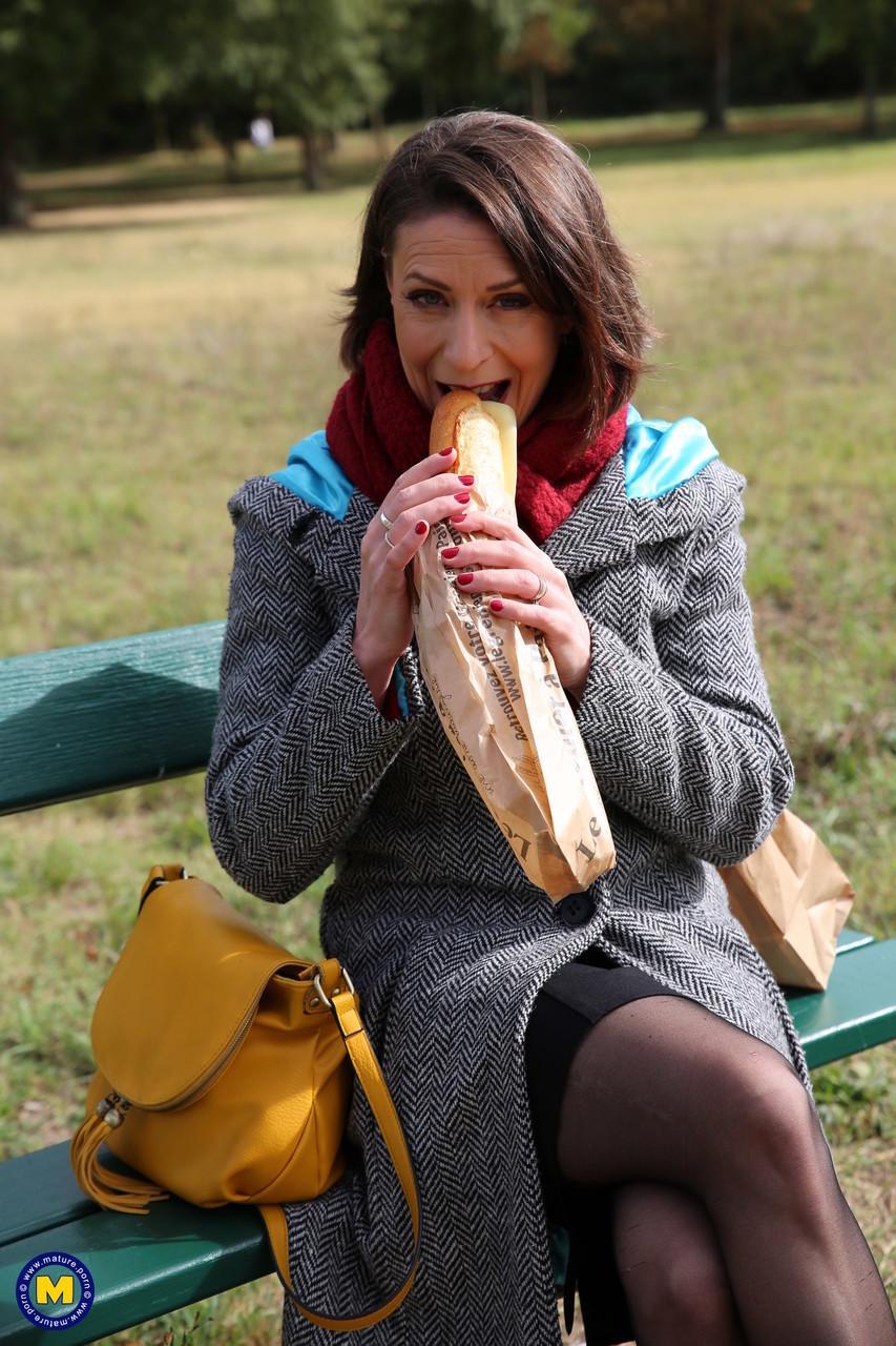 French mom Anya flashes her legs in stockings while eating a sandwich outside(5)