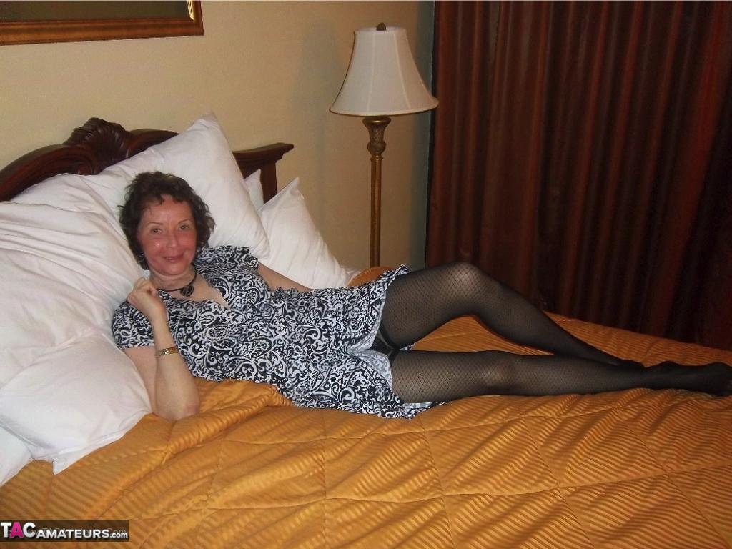 Curly haired mature woman likes sending her younger partner provocative photos(3)