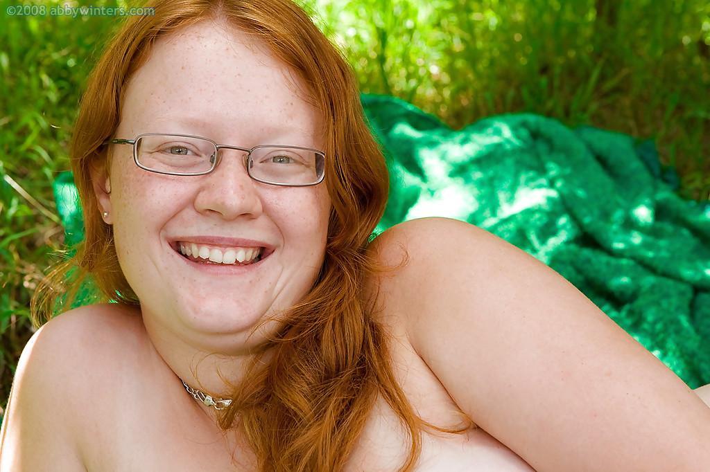 Ugly redhead chick in glasses strips naked outdoors for pussy spreading(15)