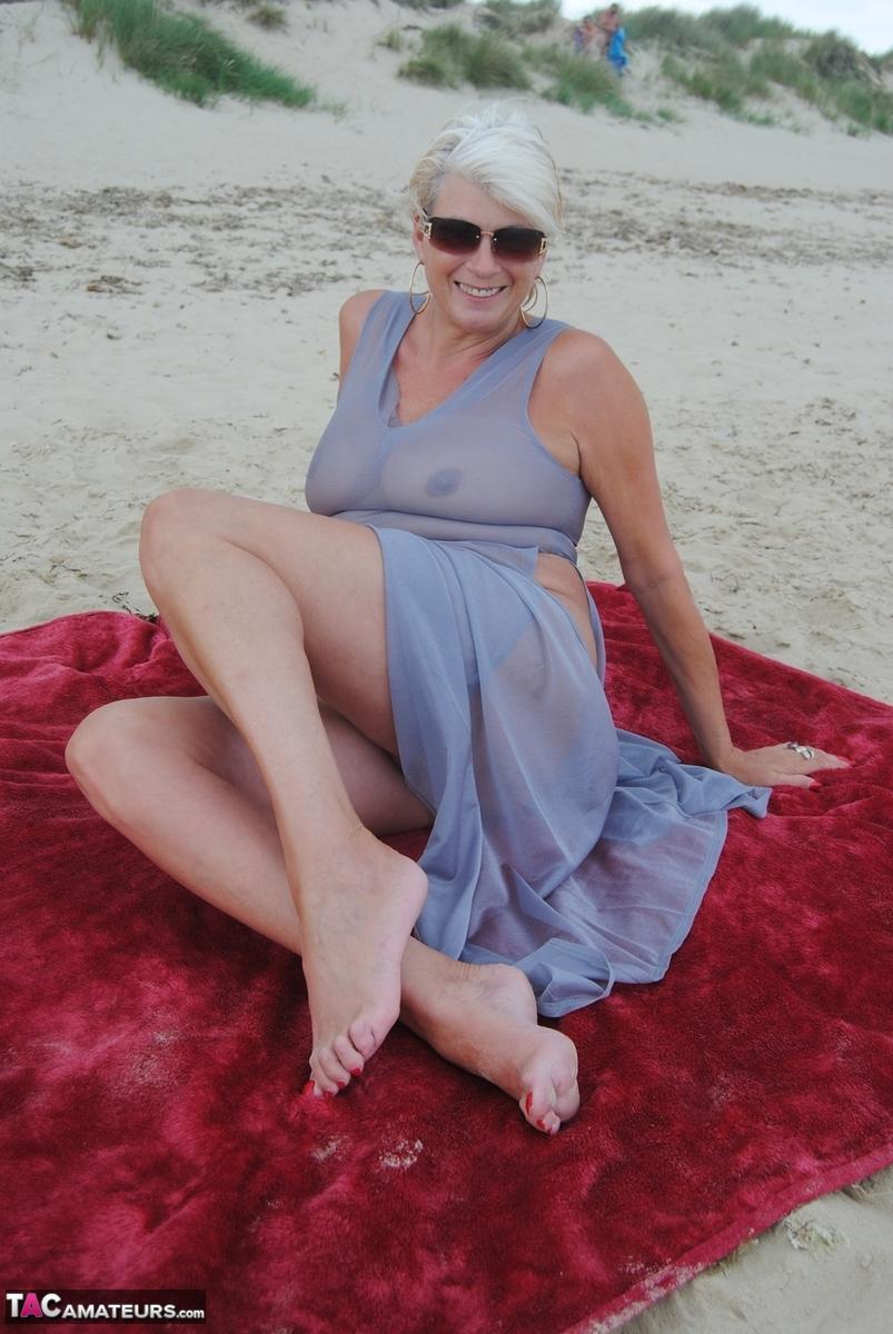 Older blonde amateur Dimonty models at the beach in see thru attire and shades(19)