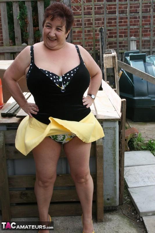 Fat older woman Kinky Carol flashes her bra and upskirt underwear on a patio(14)