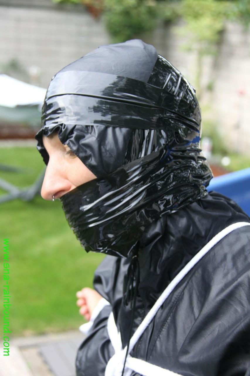 Amateur woman Sandra is gagged and tied to a pool in a raincoat(11)