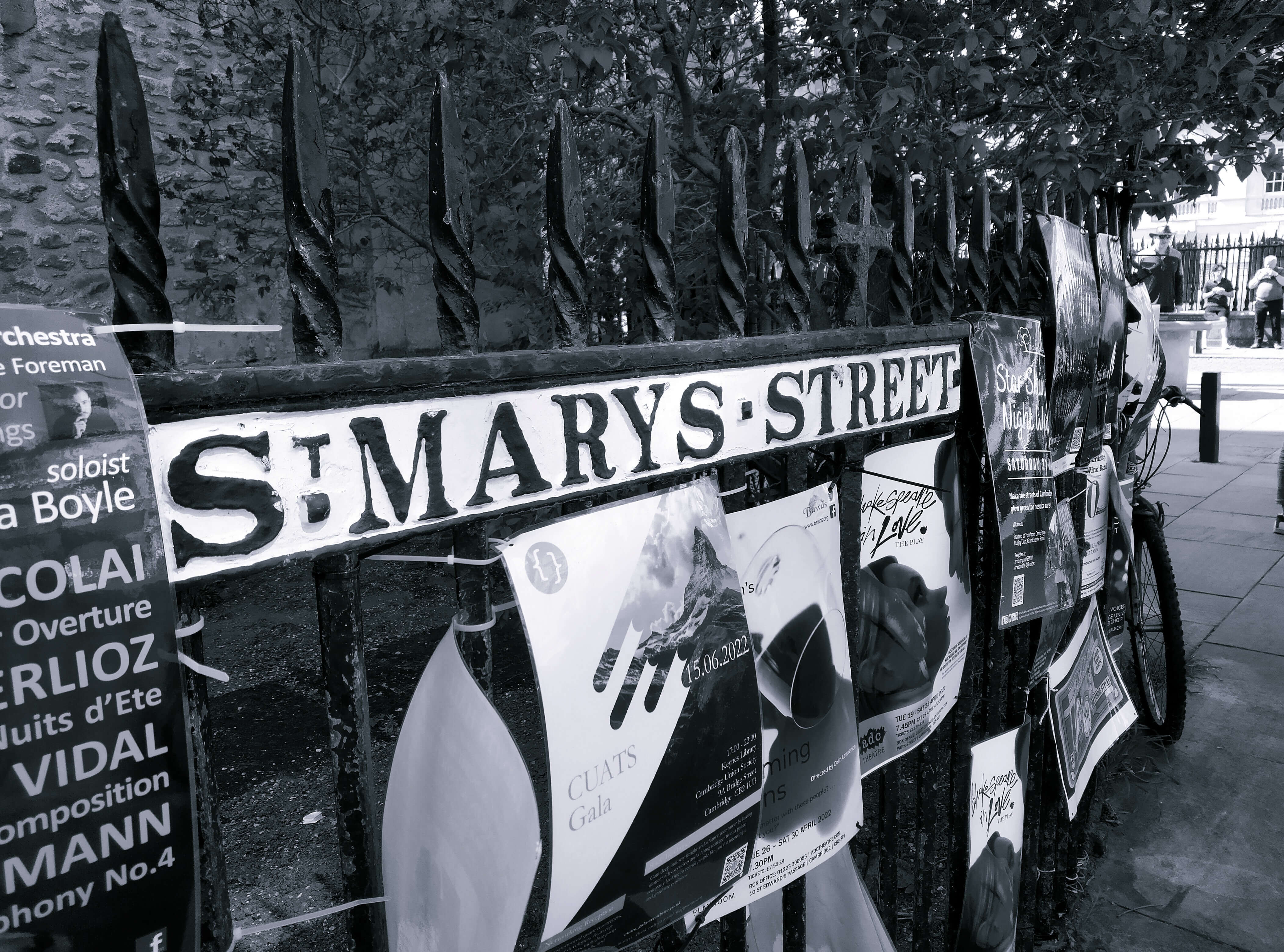 A sign for Saint Mary's Street surrounded by flyers