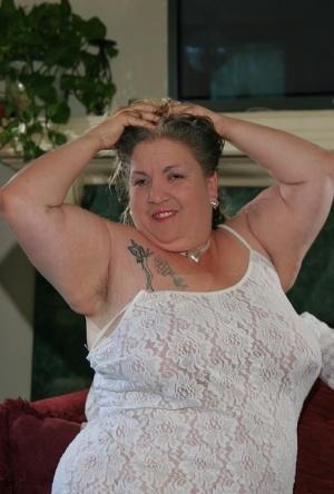 Fat mature Patty Godfrey lets out her saggy big tits and poses in a solo