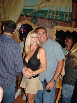 Slutty mature American wives reveal their big boobs at a swingers party