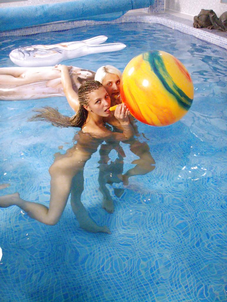 Petite teenage chicks have some lesbian fun using their toys in the pool(7)