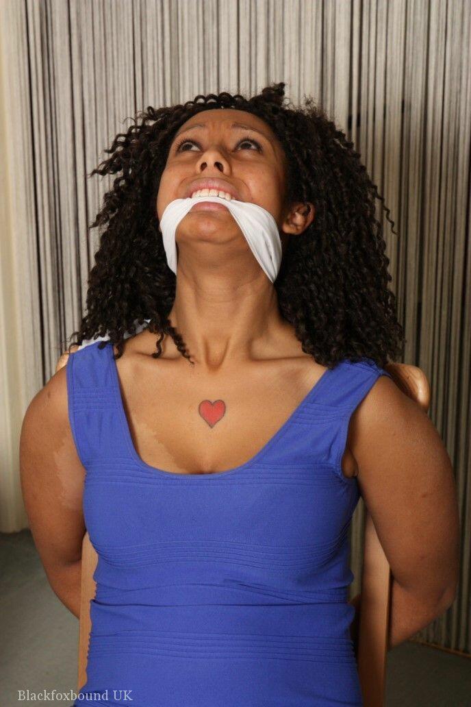 Black girl Dani is cleave gagged while hogtied in a short dress and footwear(8)