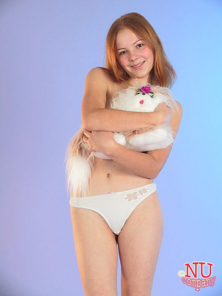 Cute redheaded teen Ola strips down naked and poses with her stuffed animal(10)