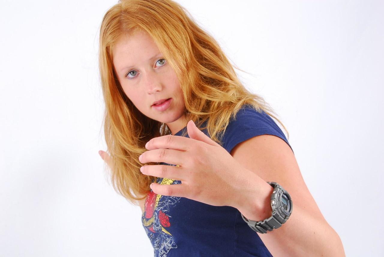 Natural redhead Judy displays her grey G-Shock watch in a T-shirt and jeans(6)