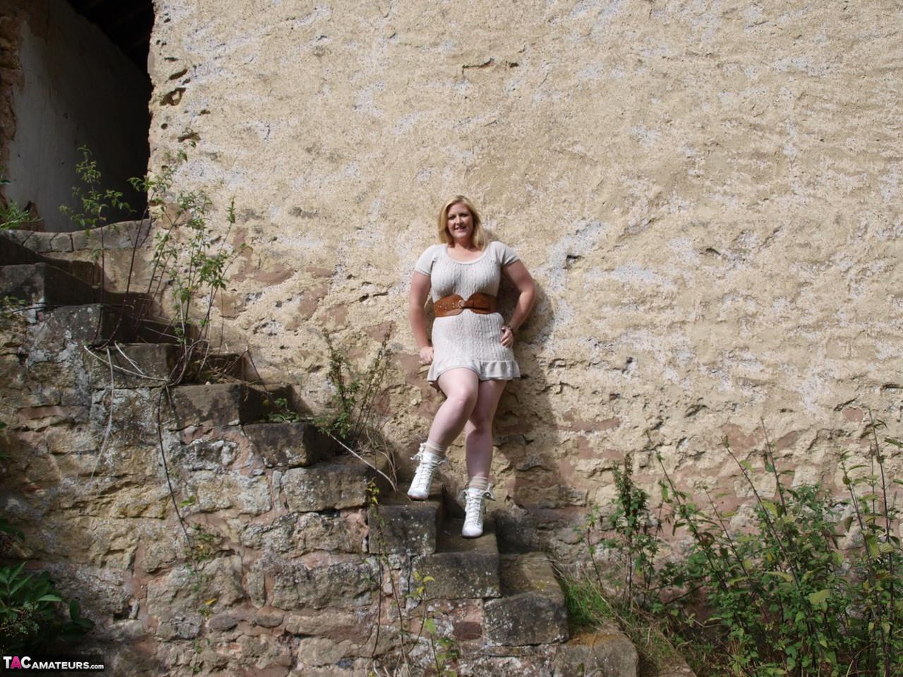 Overweight blonde Samantha gets naked in the doorway of an abandoned building(1)