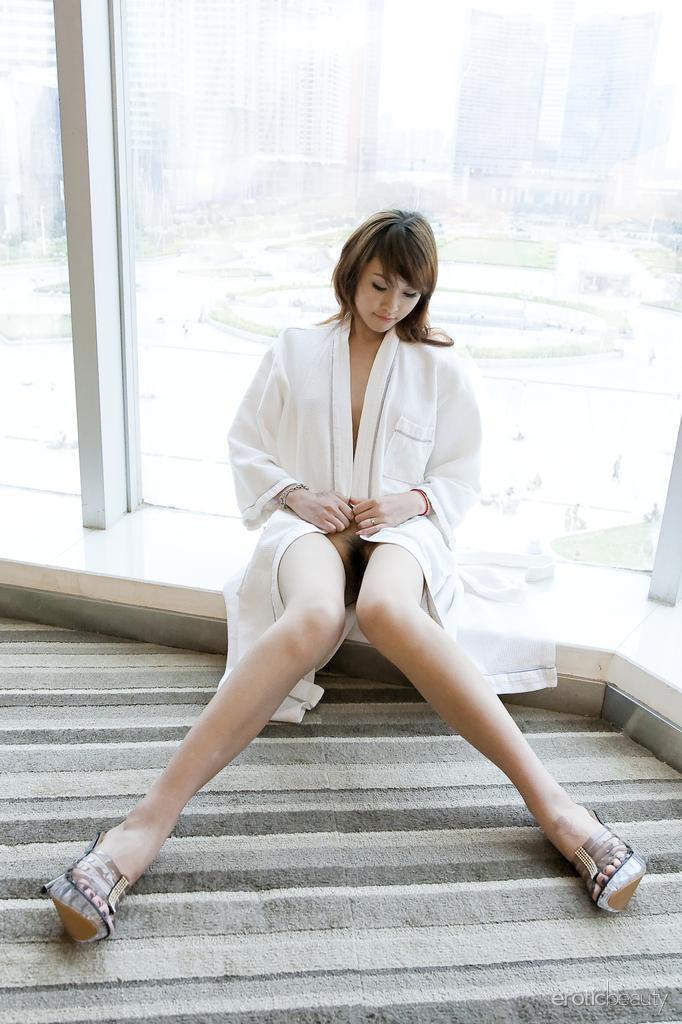 Petite Asian teen Lavinia Chan doffs a robe to pose naked on a window sill(1)