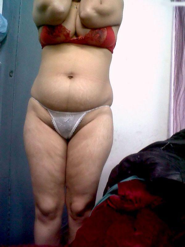 Fat Indian woman hides her face while adorned in a bra and thong(10)