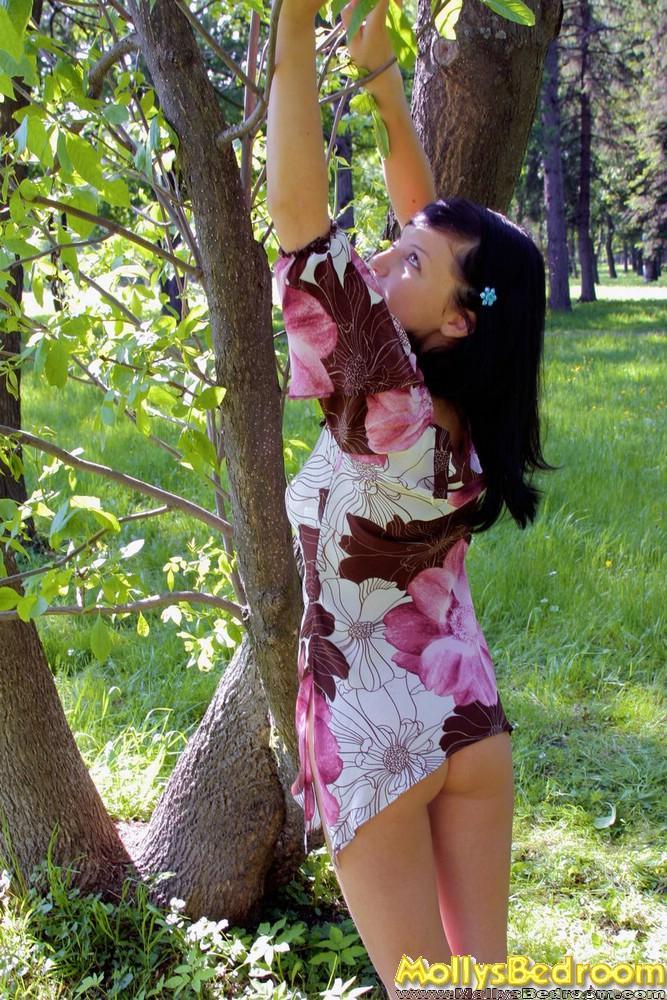 Young looking brunette with full breasts exposes herself in a treed area(14)