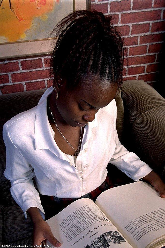 Ebony schoolgirl Jezebel toys herself as she strips to her white stockings(2)