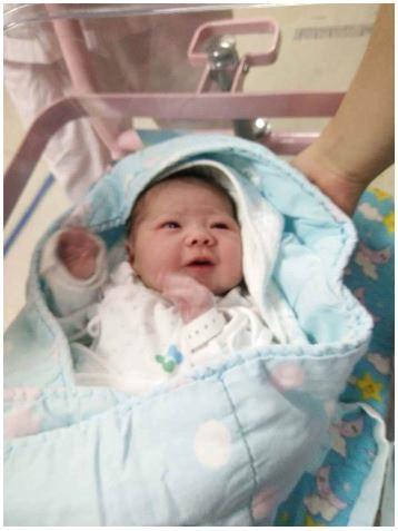 Newborn in a bassinet.