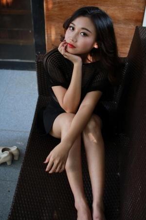 Beautiful Asian girl shows off her petite body wearing a sexy black dress