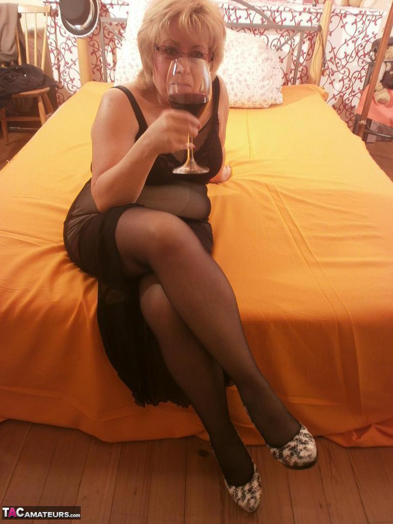 Tipsy hot granny Caro spreading legs on the bed wearing black stockings(2)