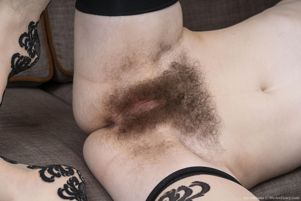 Delightful inked amateur Ivy Addams shows her hairy armpits & twat on a couch(16)