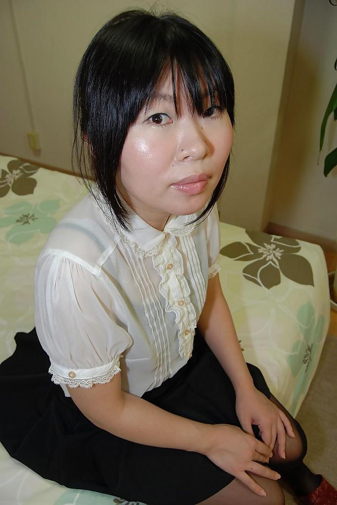 Sassy asian MILF strips down and gets her shaved gash fingered(1)