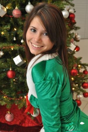 Amateur Xmas elf Hailey lifts her tight skirt to show her sexy ass by the tree