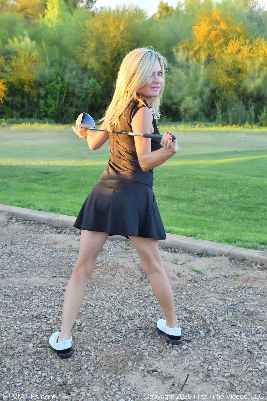 Seductress Hilary flashes her panties & shows her cleavage while playing golf(12)