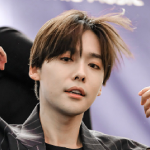 An icon of Sunyoung. His hair is in motion, mussed up from when he was fixing it in the first icon. He is looking directly into the camera.