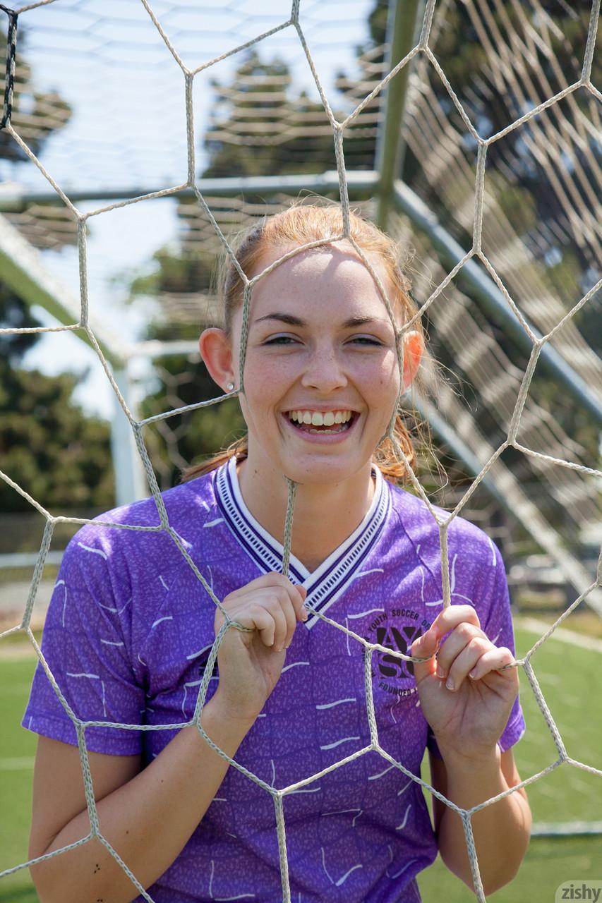 Sporty redhead teen Bailey Rayne flashes her tight ass on the soccer field(4)