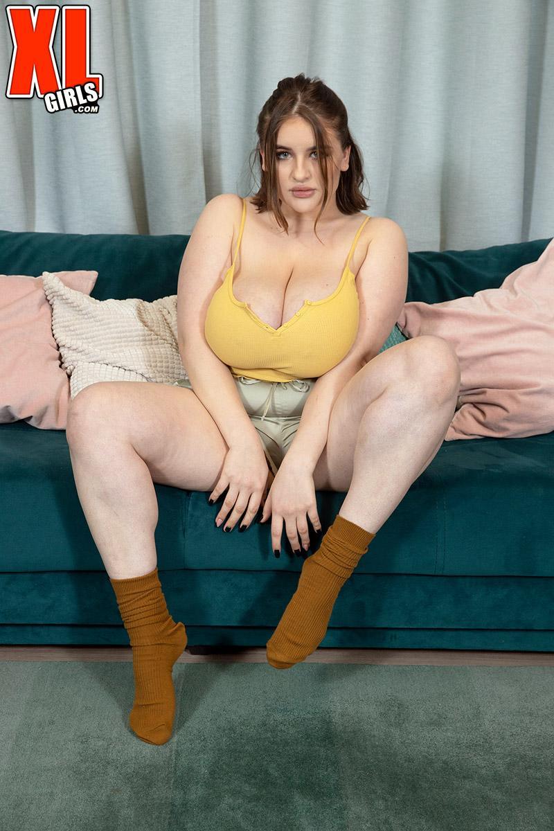 Solo girl Molly Evans pulls out her massive boobs upon a sofa(3)