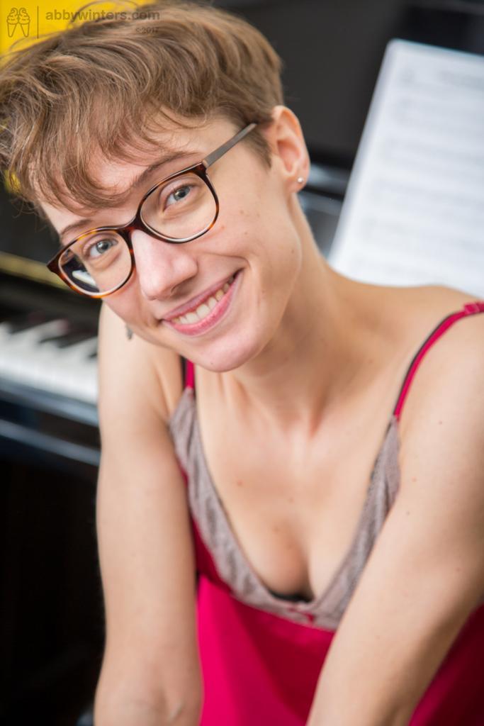 Thin amateur with short hair shows off her beaver on piano bench(1)